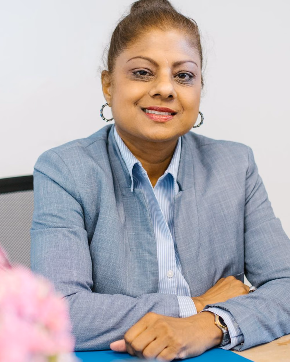 A friendly insurance advisor in a Dubai office